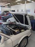 OEM 3-piece hood insulation pad set for BMW E30 by Genuine BMW displayed on White E30 in Shop